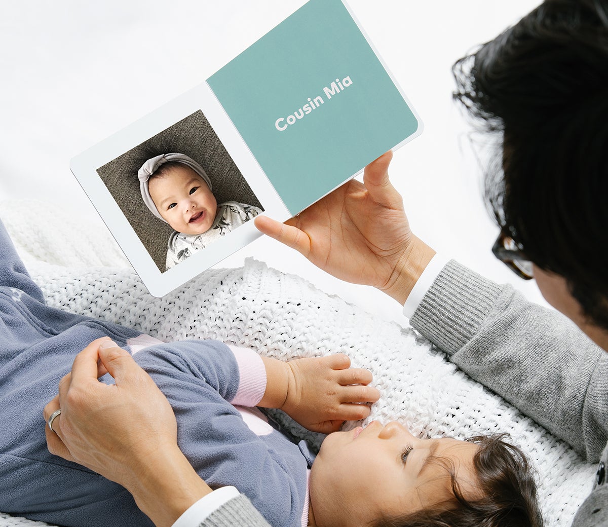 Grandmother reading Baby Board Book with little one