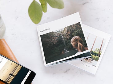 Softcover photo book with photo of woman facing waterfall