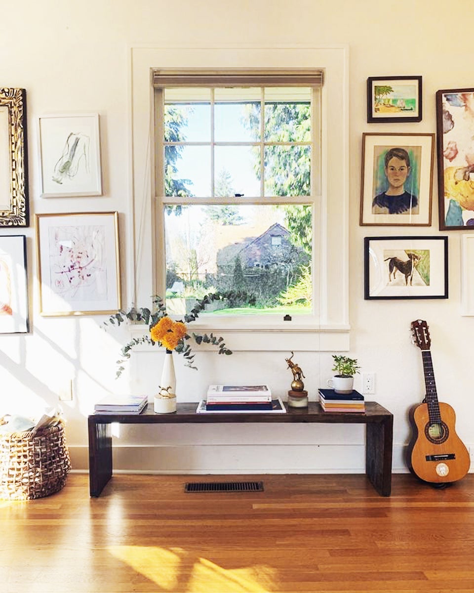 Vibrant gallery wall with large window at the center