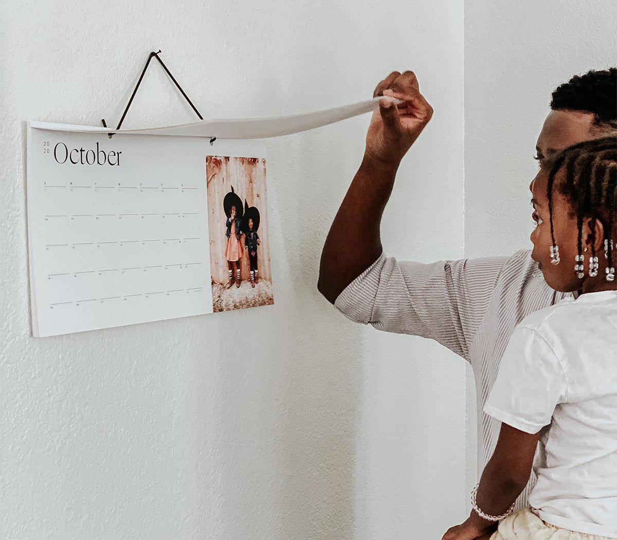 Photo by @mrshazleybaby of father and daughter flipping through Modern Wall Calendar