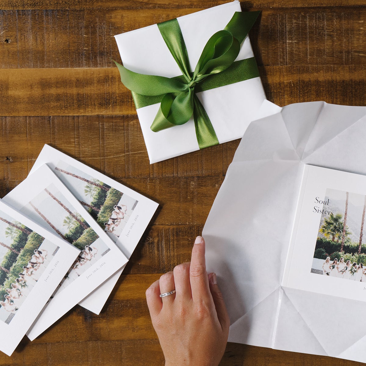 Hands wrrapping Artifact Uprising Softcover Photo Books made for bridesmaids