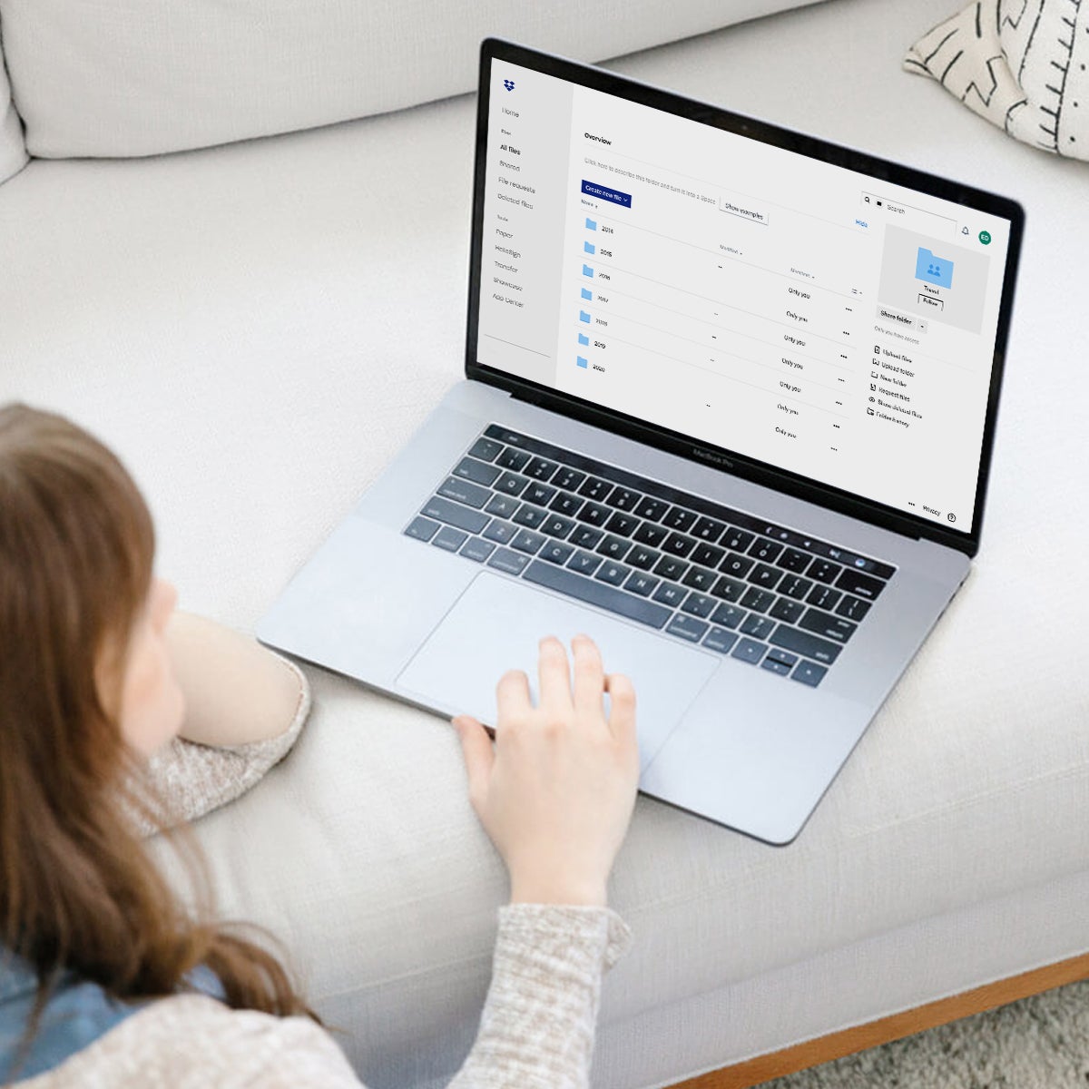 Woman organizing file folders on laptop