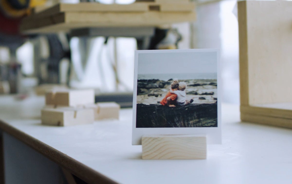 photo print of mother and child hugging displayed on wood print block