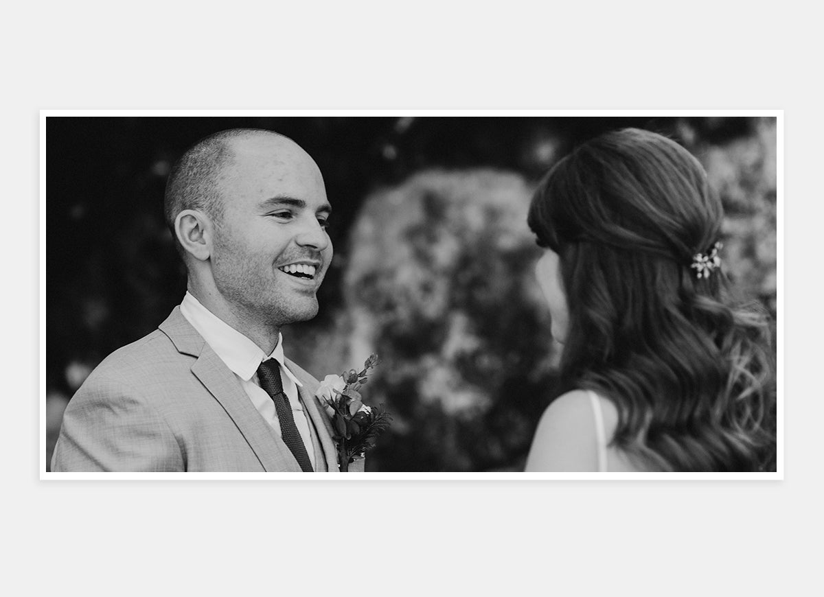 Two-page, black and white photo in wedding album of bride and groom looking into each other's eyes