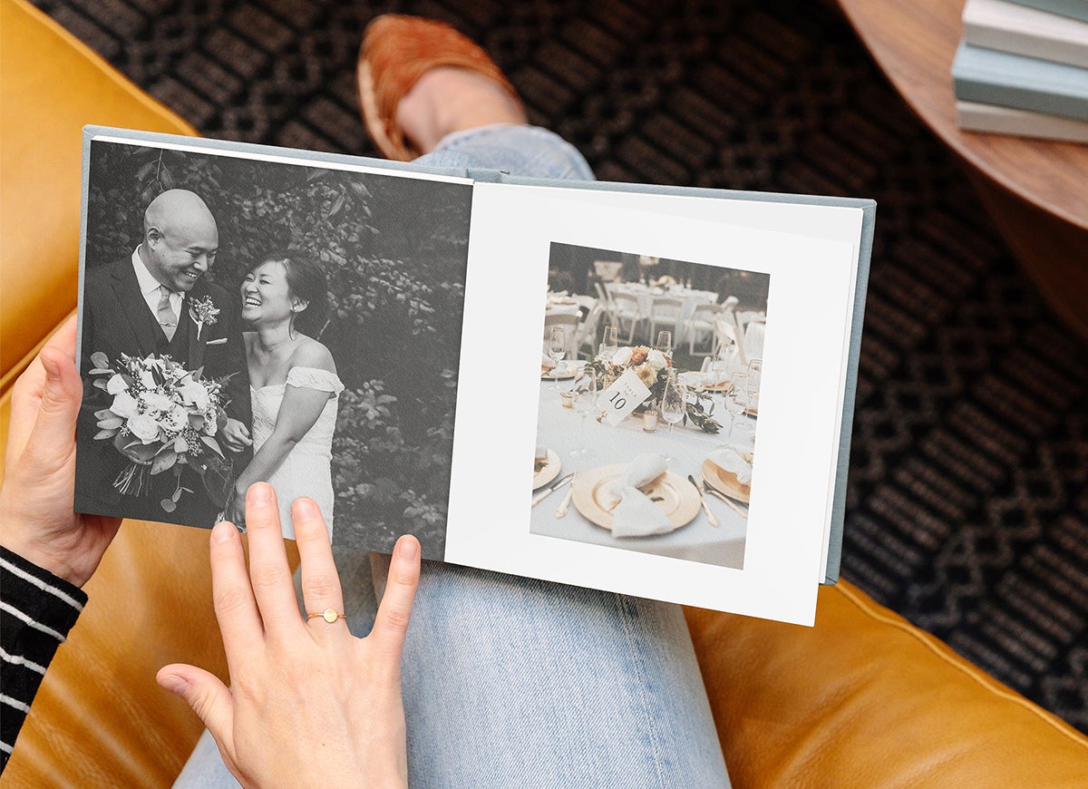 Woman's hands flipping through Everyday Photo Book filled with wedding photos