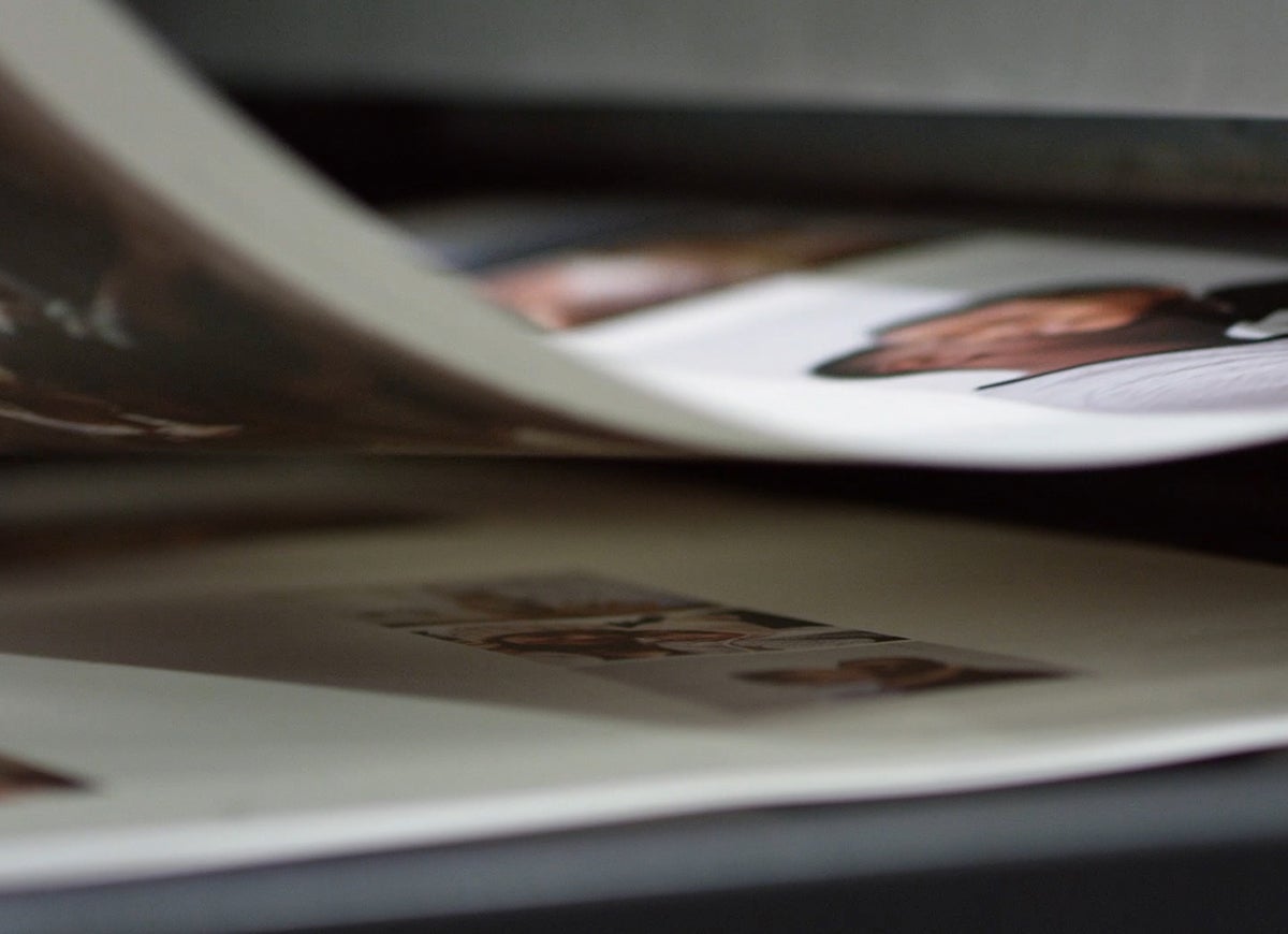 Zoomed in on pages of an artifact uprising photo book rolling off printing press