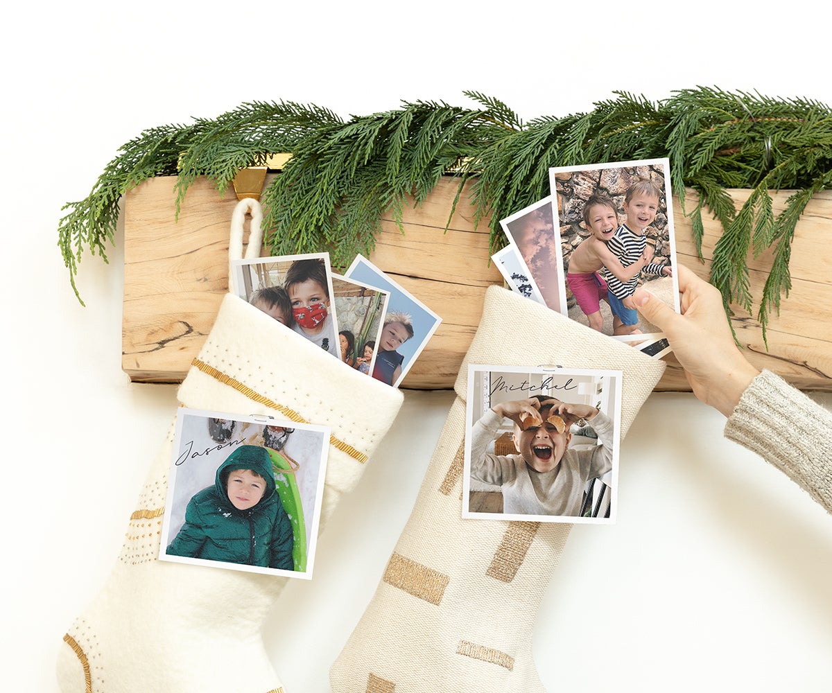 Hand placing photo print on top of wrapped gift as gift tag