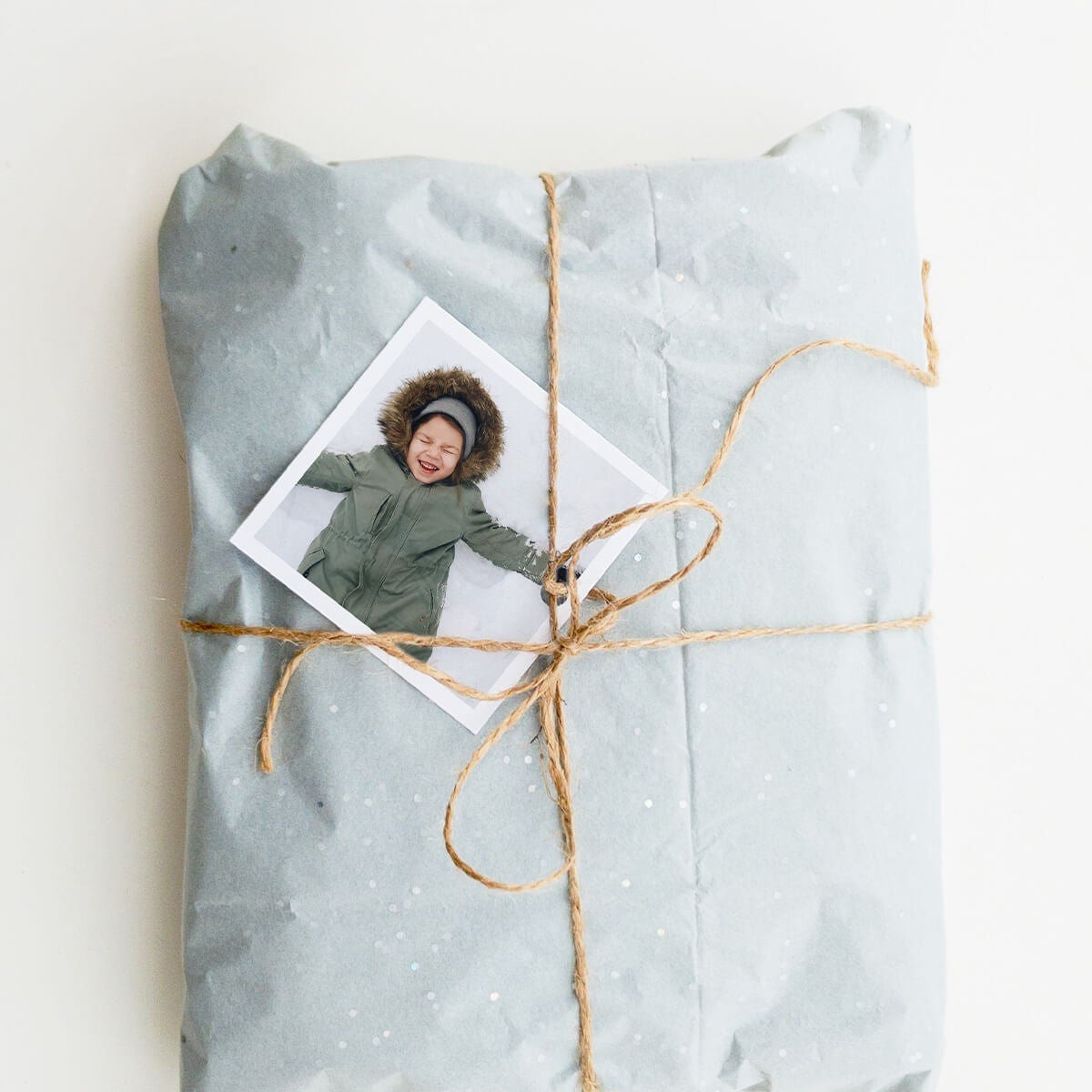 Artifact Uprising photo print secured to wrapped gift with twine