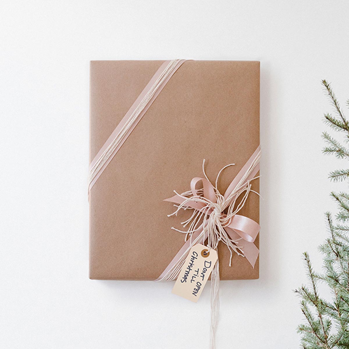 Wrapped frame hanging on wall with gift tag