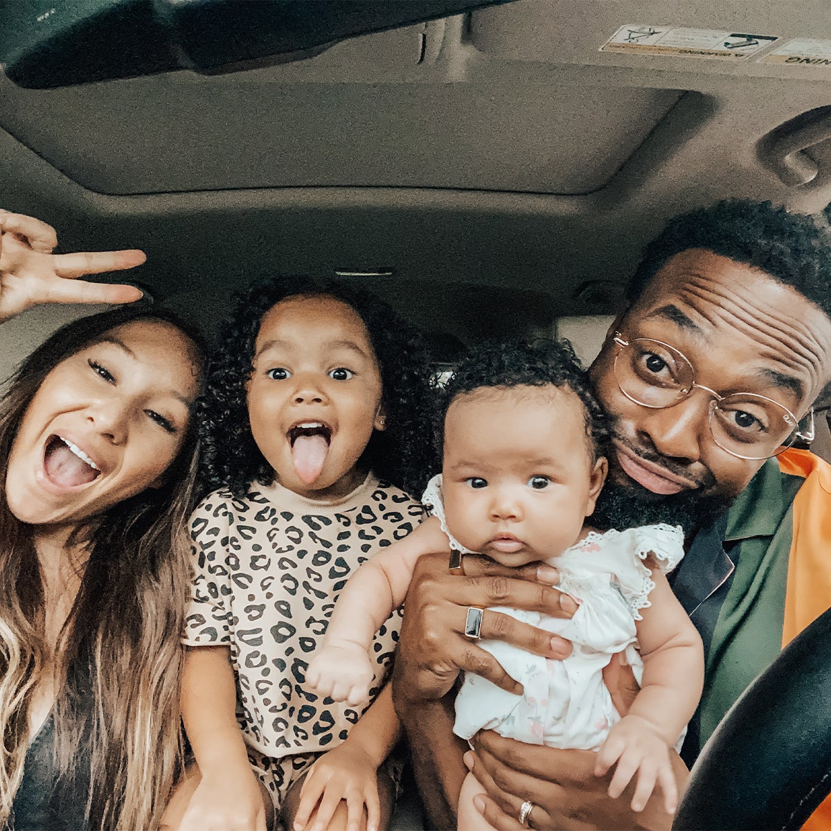 Family taking goofy selfie in car