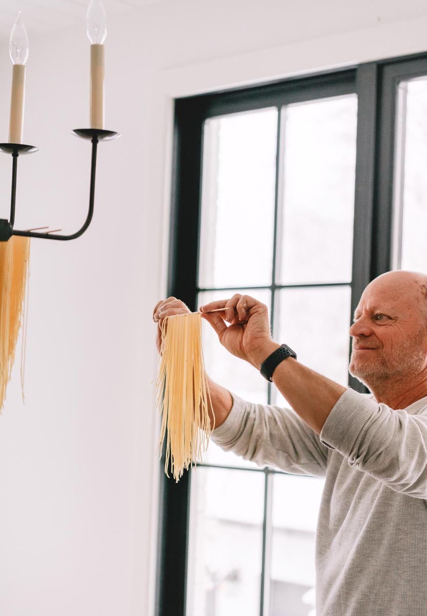 Man hanging homemade pasta
