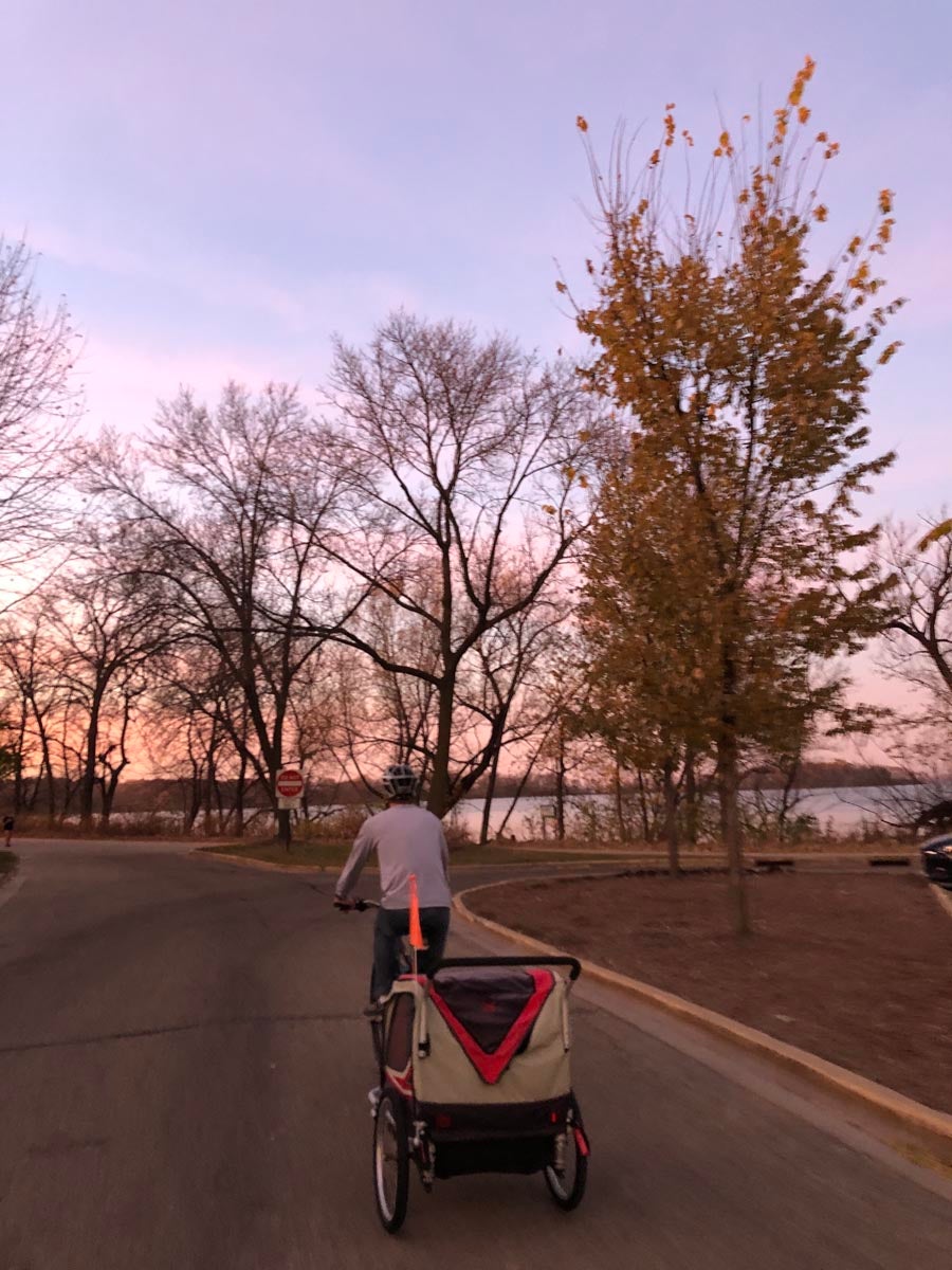 Man riding bike by a lake