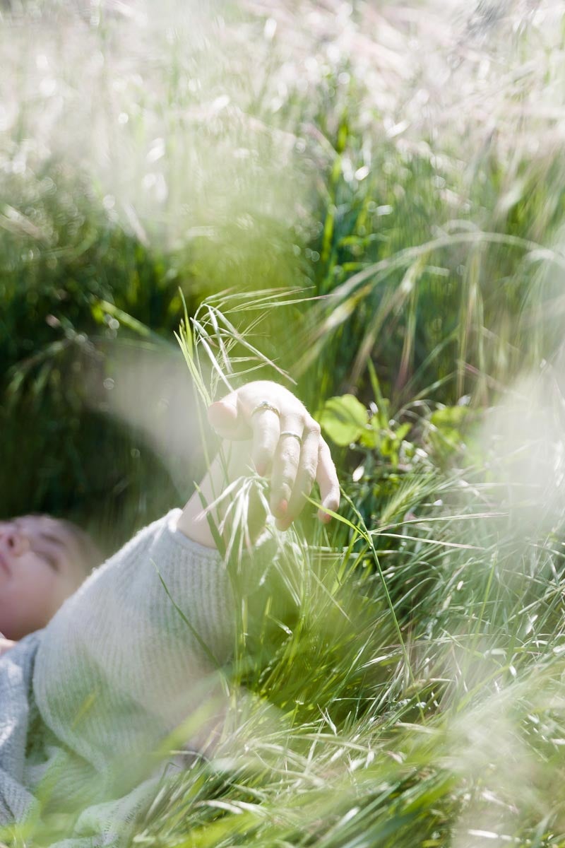Photo by Kelly Sweda of girl lying in the grass