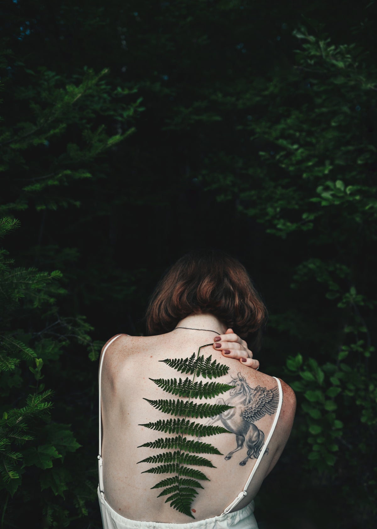 Portrait of woman with back turned to camera by Molly Olwig