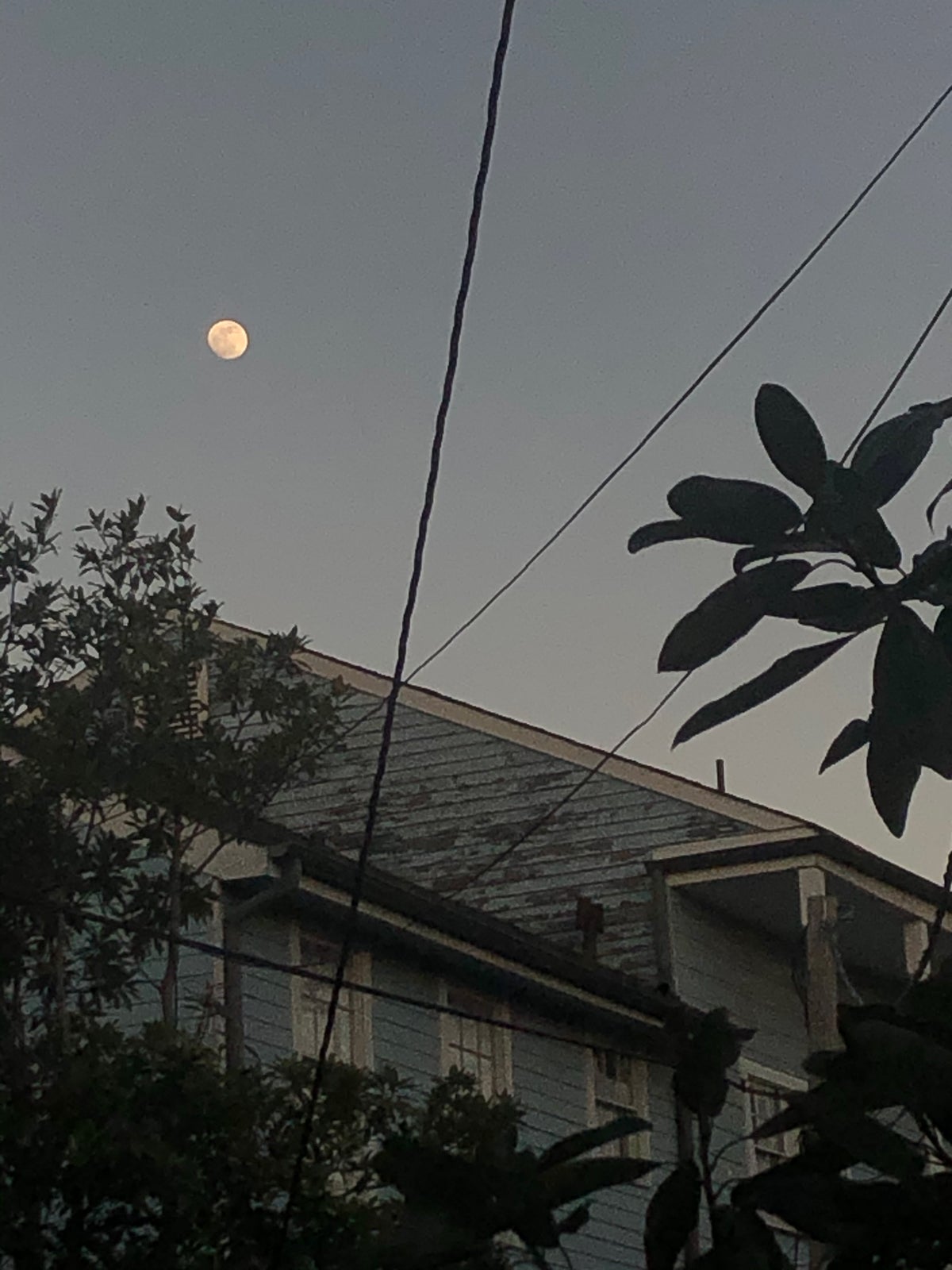 Photo of moon above old house by Molly Olwig