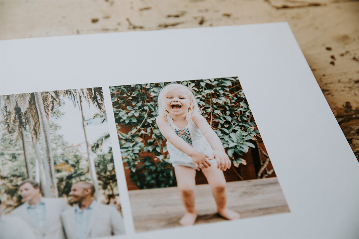 Signature Layflat Album opened to image of little girl laughing and dancing