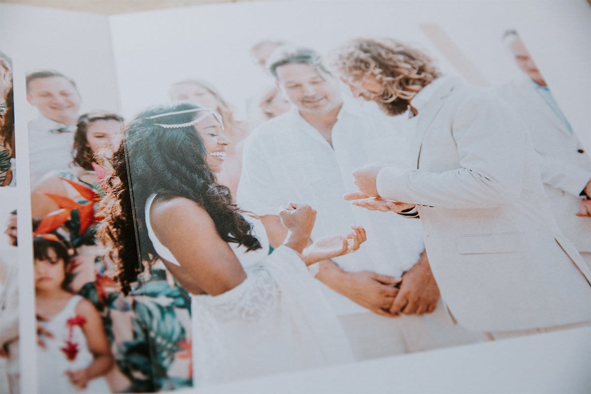 Zoomed in on album opened to image of bride and groom during ceremony