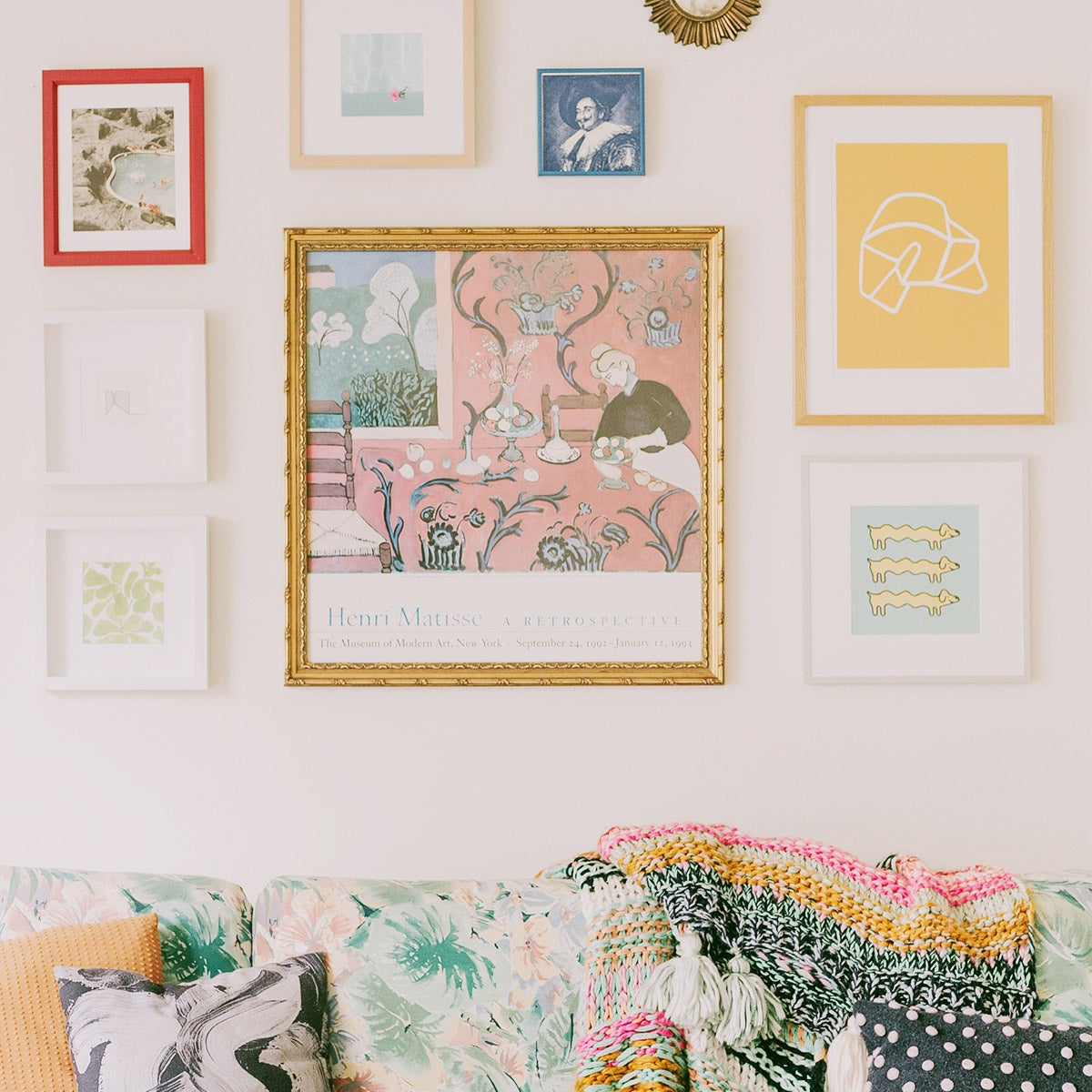 Vibrant gallery wall featuring Artifact Uprising frames hung above vintage pastel couch