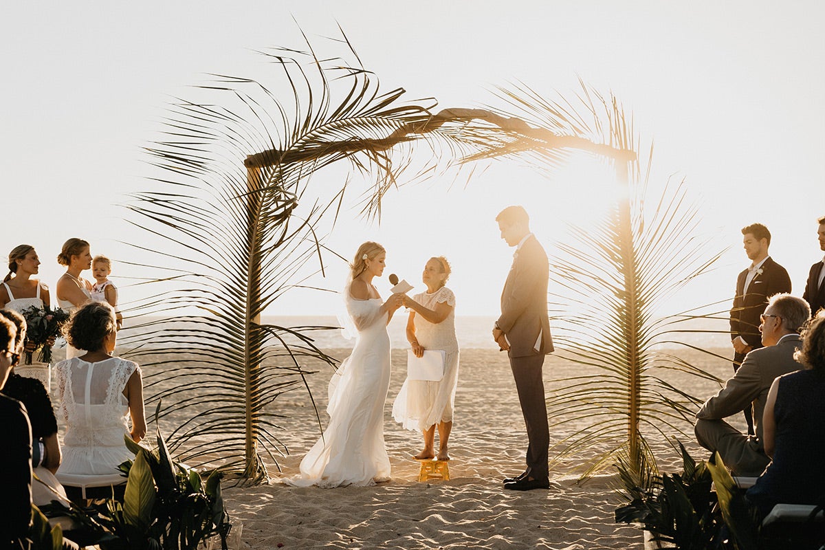 Bride and groom exchanging vows on the beach