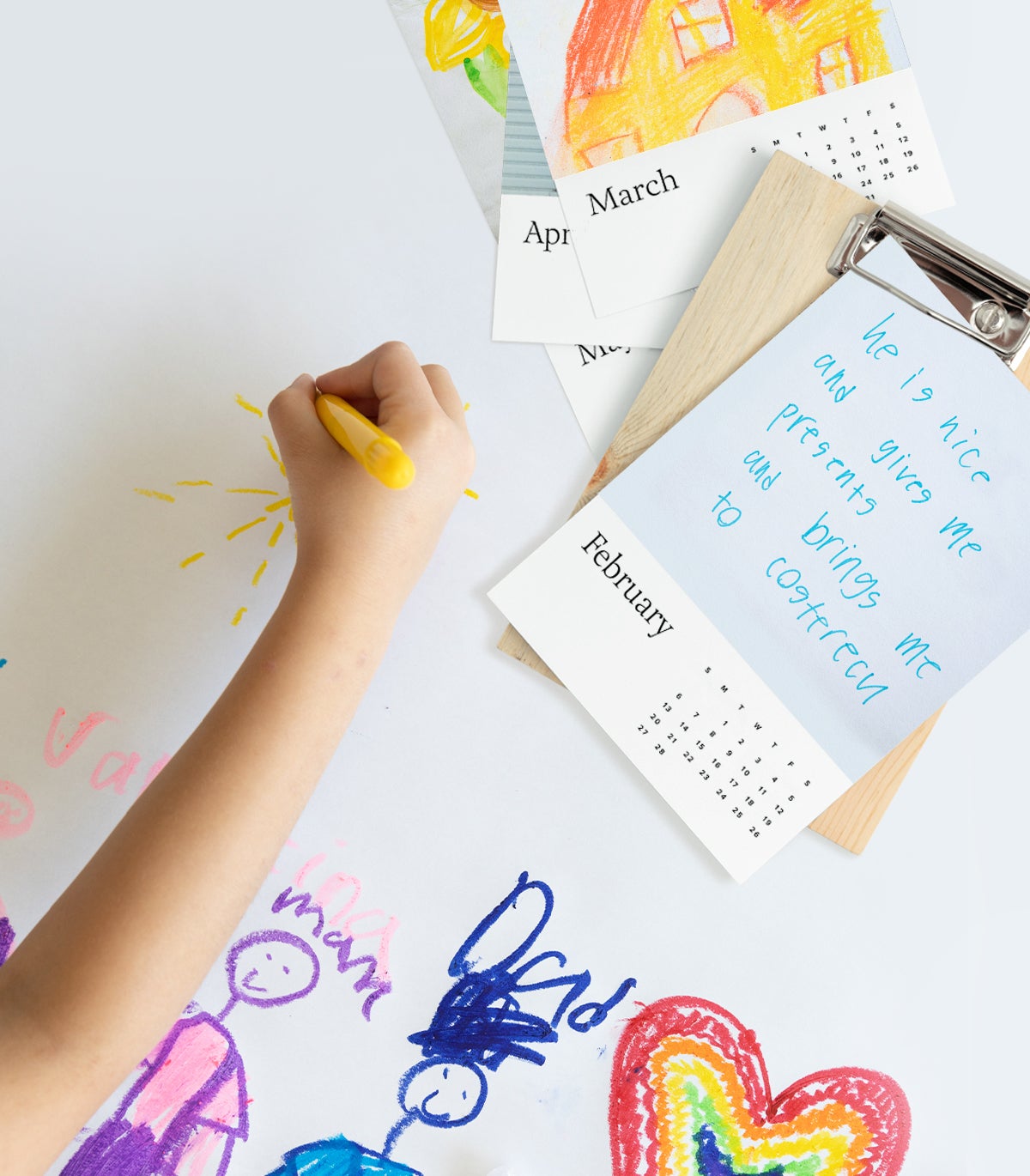 Child's hand drawing next to Artifact Uprising Wood Calendar featuring notes they wrote to dad