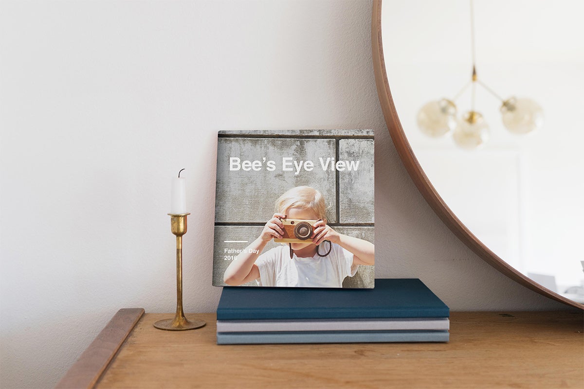 Artifact Uprising Hardcover Photo titled Bee's Eye View featuring photo of little girl looking through camera