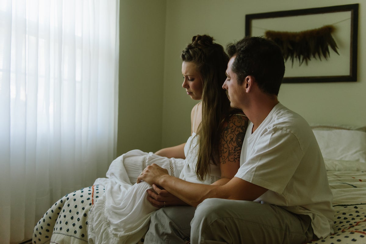 Portrait of husband consoling wife taken by Martha Swann-Quinn