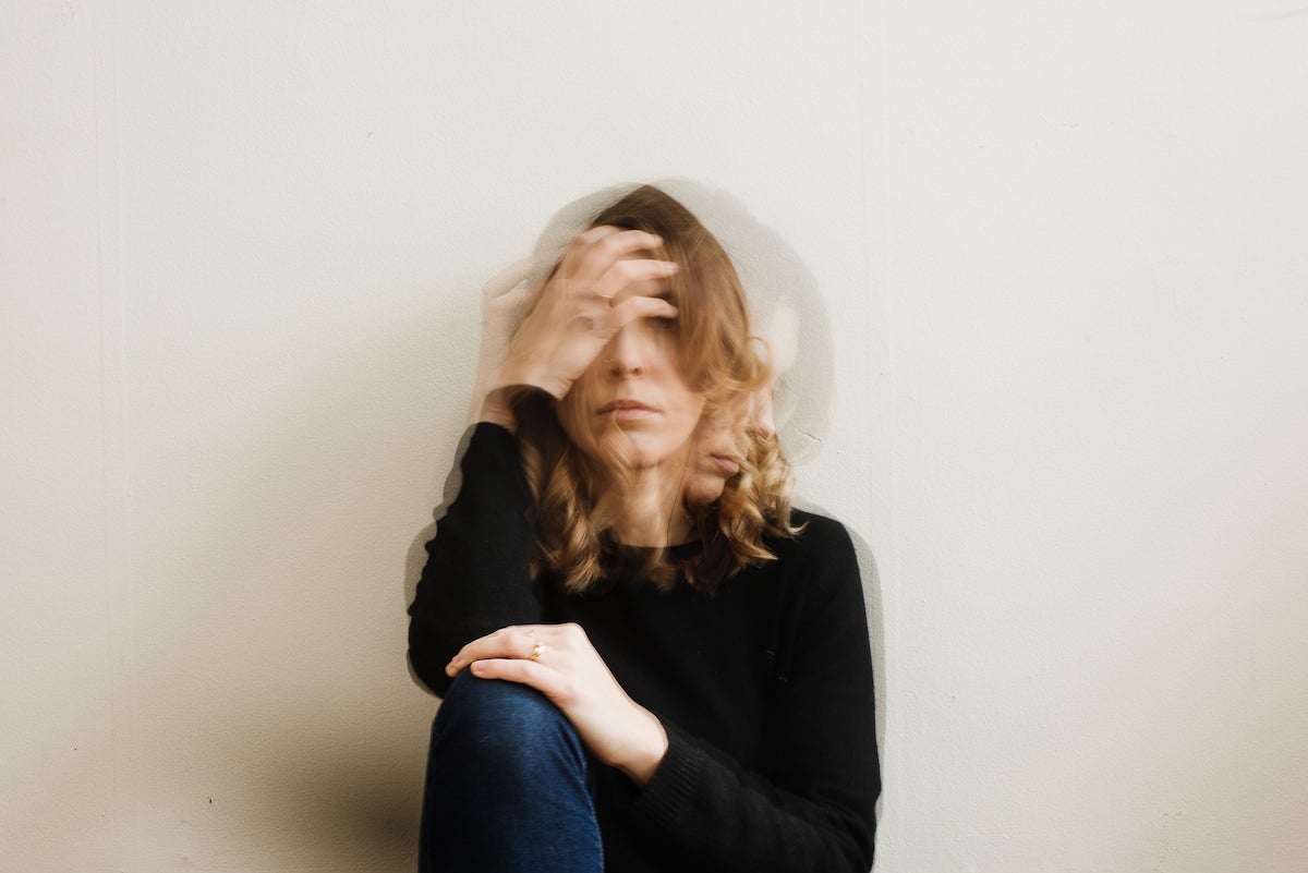 double exposure photo by Martha Swann-Quinn of woman sitting against the wall