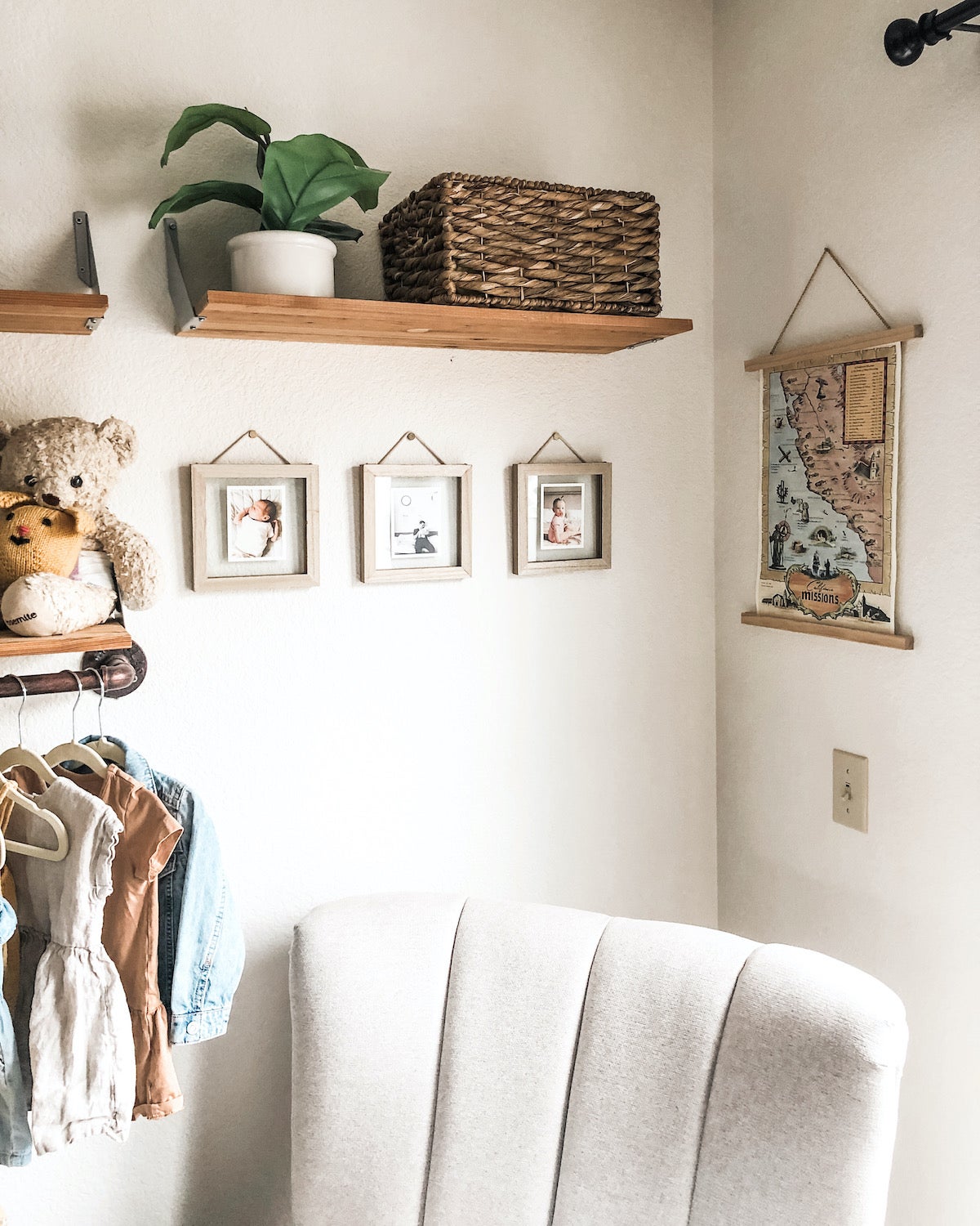 Trio of framed Artifact Uprising Everyday Photo Prints on nursery wall below floating shelf and above armchair