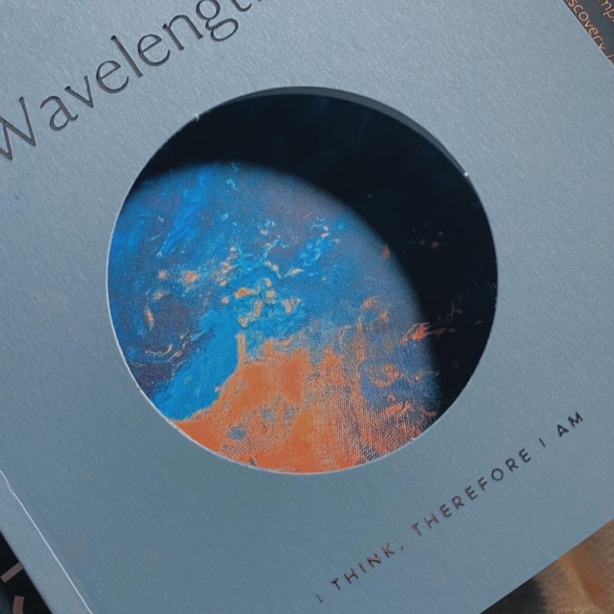 Artifact Uprising Color Series Photo Book titled wavelengths showing glimpse of a painting through the peek-through cover