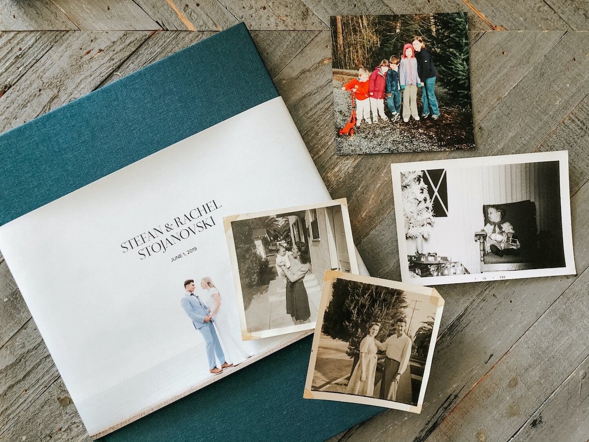 Artifact Uprising Hardcover Wedding Photo Book on coffee table along with various photo prints