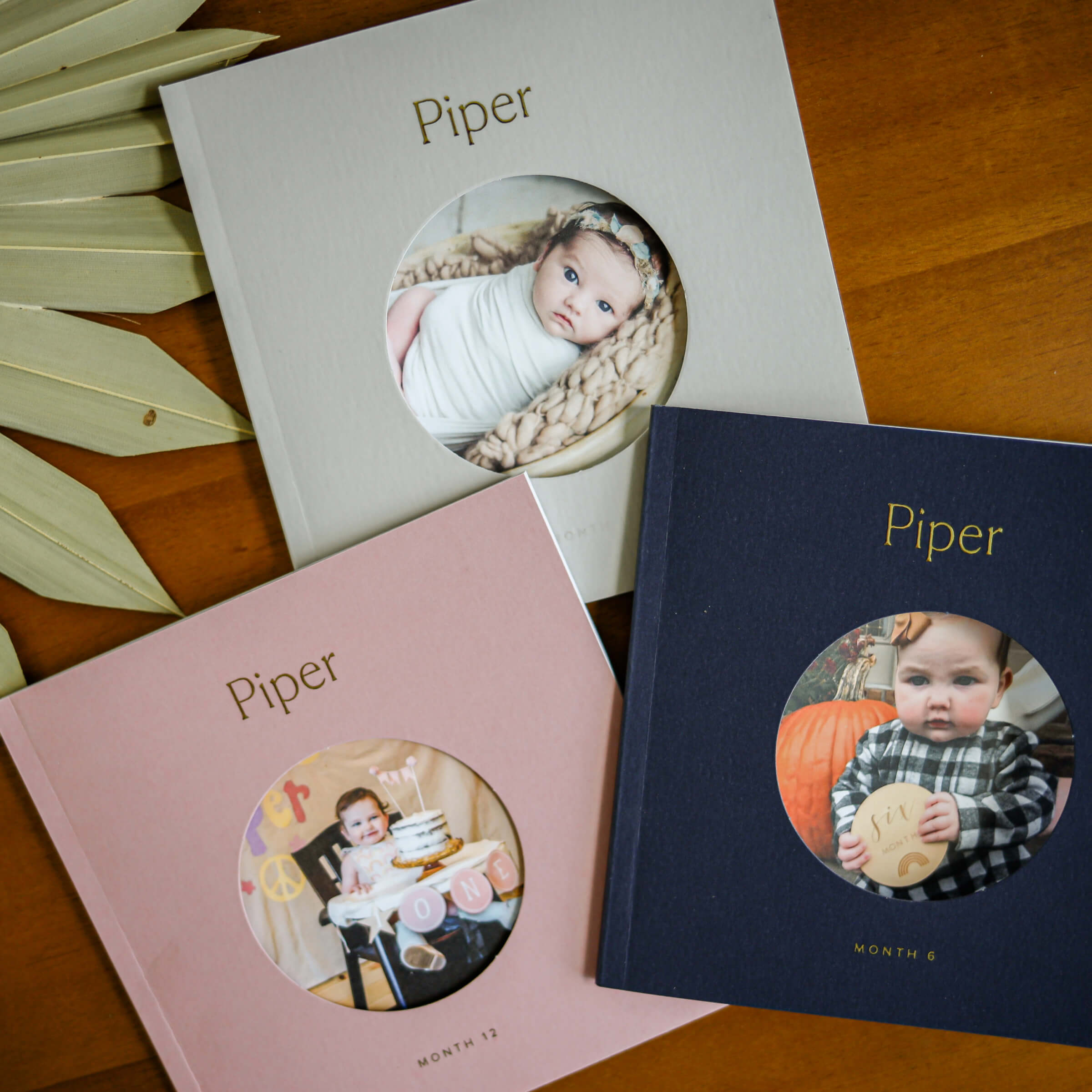 Three Artifact Uprising photo books of a baby growing up
