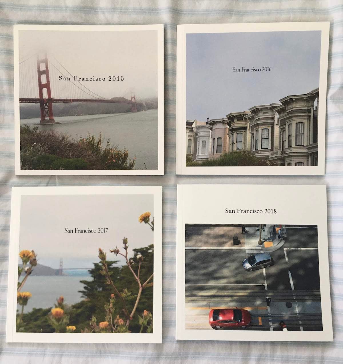 Four small Artifact Uprising Softcover Photo Books of vacations to San Francisco from different years