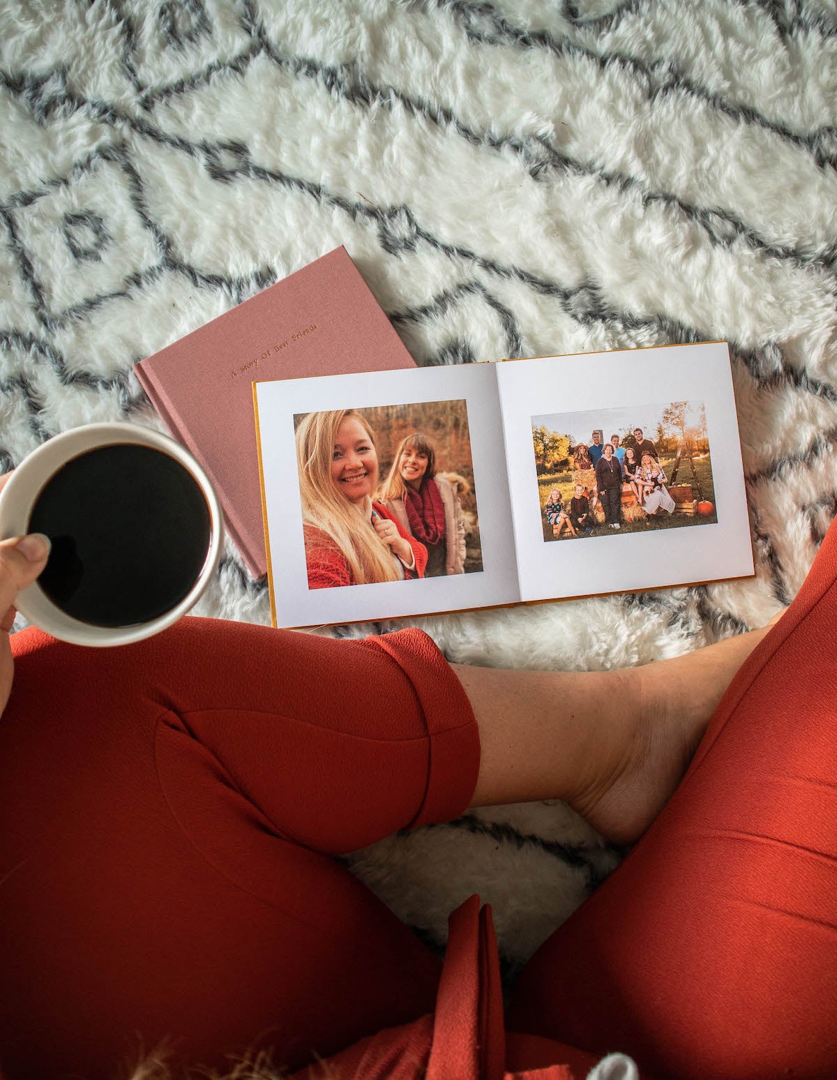 Woman looking at a photo book of her friends