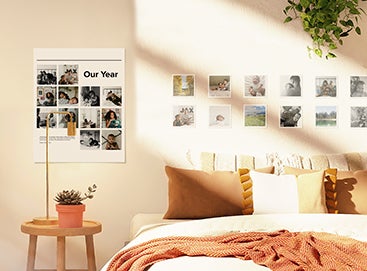 A bedroom wall styled with a photo poster and a grid of photo prints. 