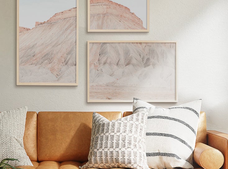 A creative gallery wall display splitting one photo of a mountain into three frames.