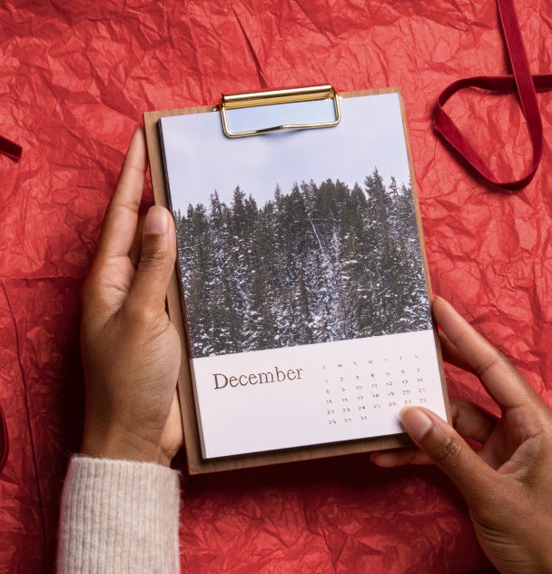 Walnut Desktop Photo Calendar showcased on tissue paper and ribbon 