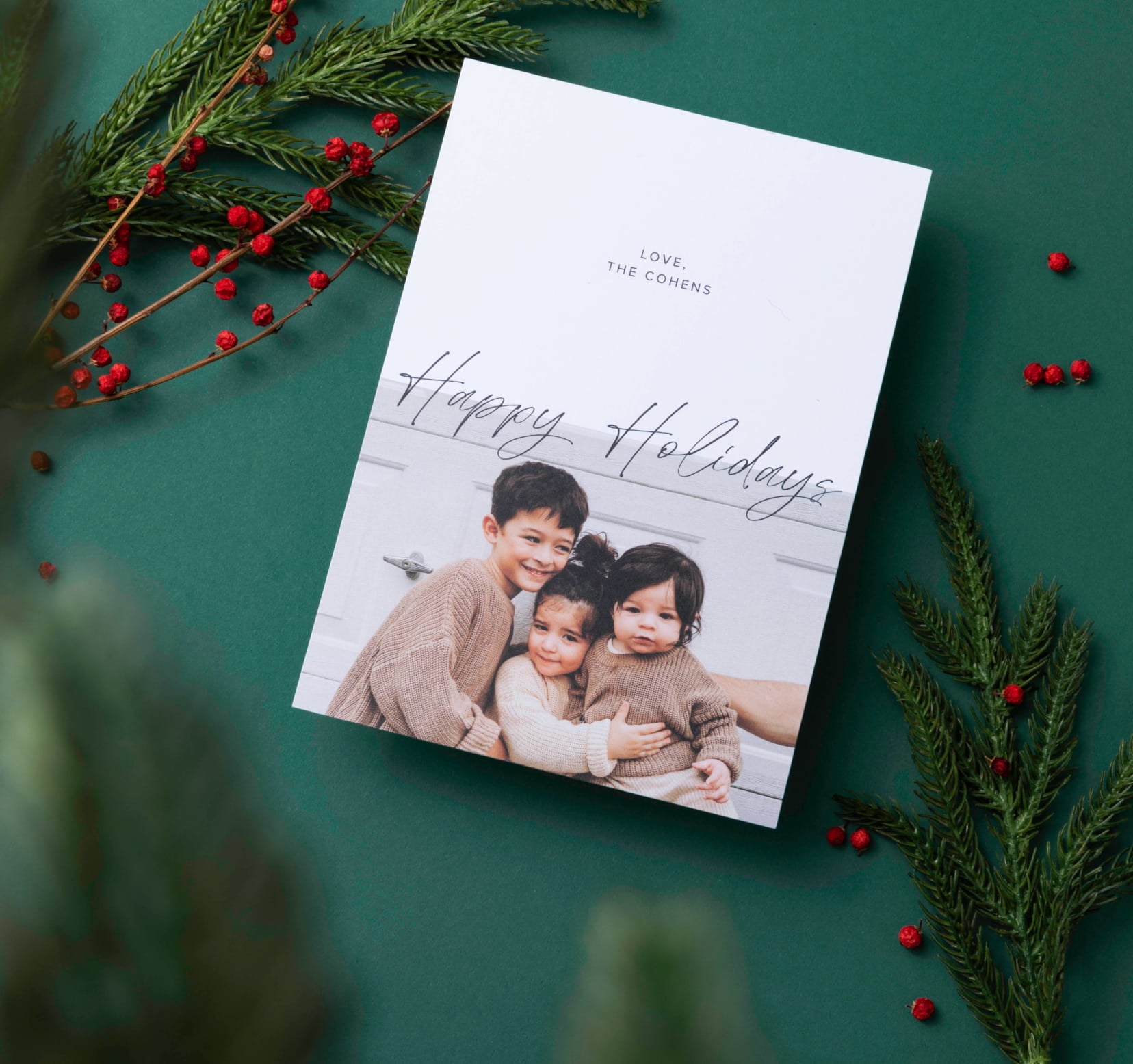 Holiday card showing 4 pictures of kids in matching Christmas pajamas