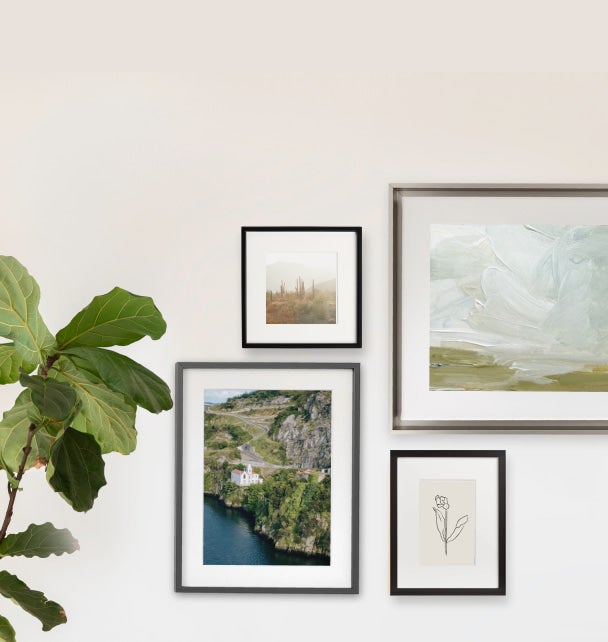 Four metal frame gallery wall with mix of landscape and art prints