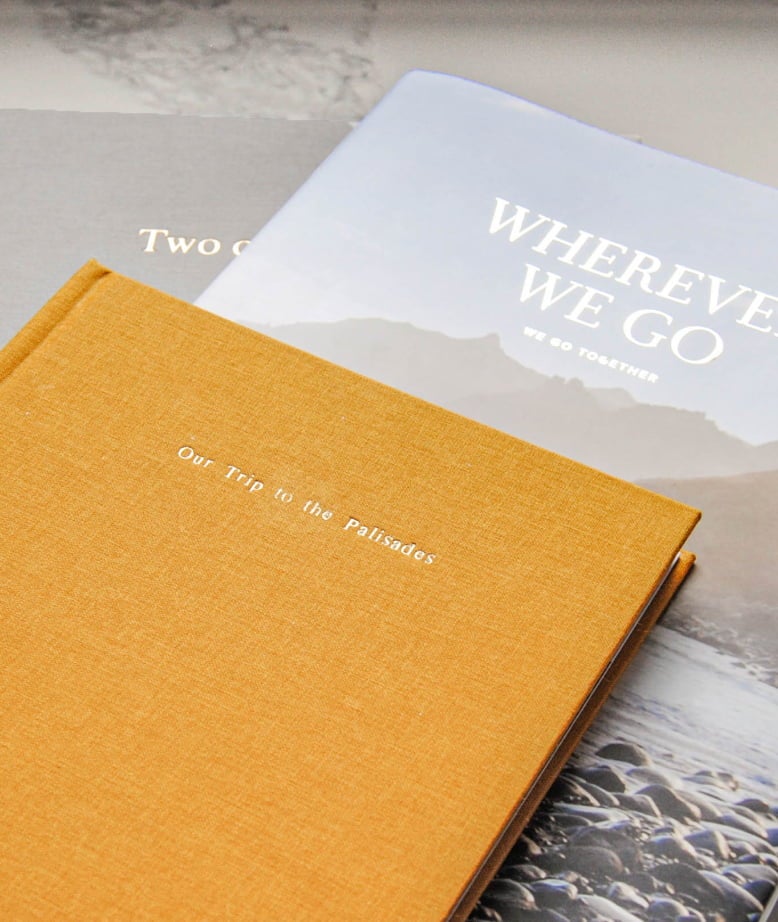 Three photo books stacked on each other with travel titles