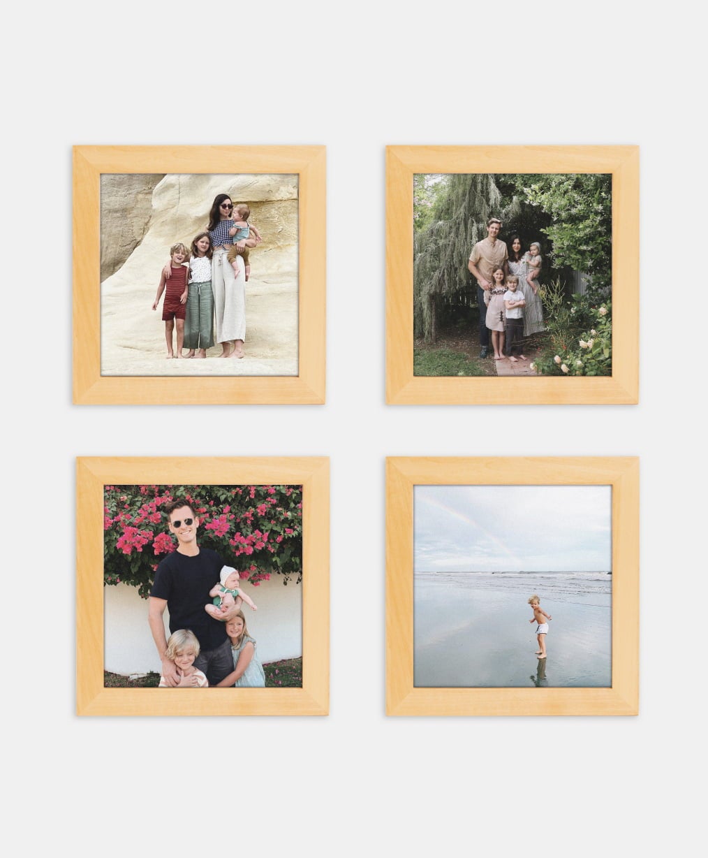 Four wood frames on a gallery wall showing family photos