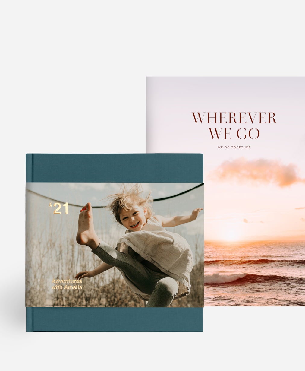 Two hardcover photo books, one kid’s photo book and one travel photo book