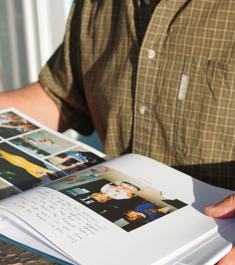 Open Hardcover Photo Book featuring unique image page layouts and custom note being enjoyed father