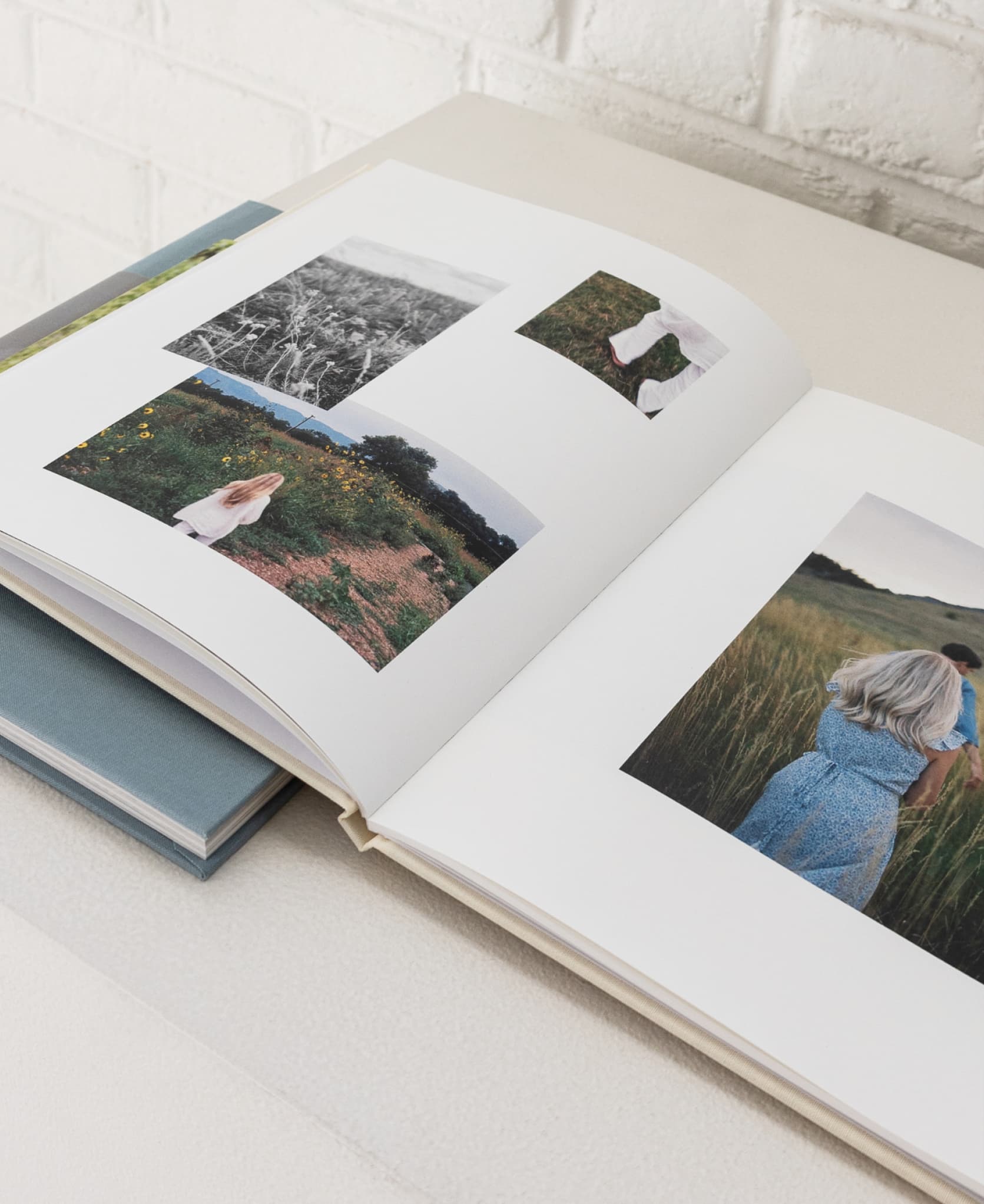 Open hardcover photo book showcasing unique page layout design