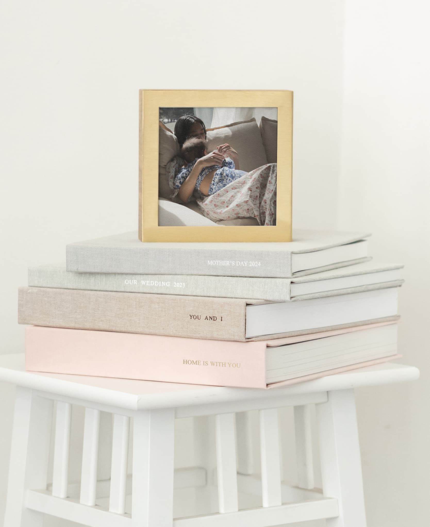 photo albums stacked showcasing brass & wood display box on top