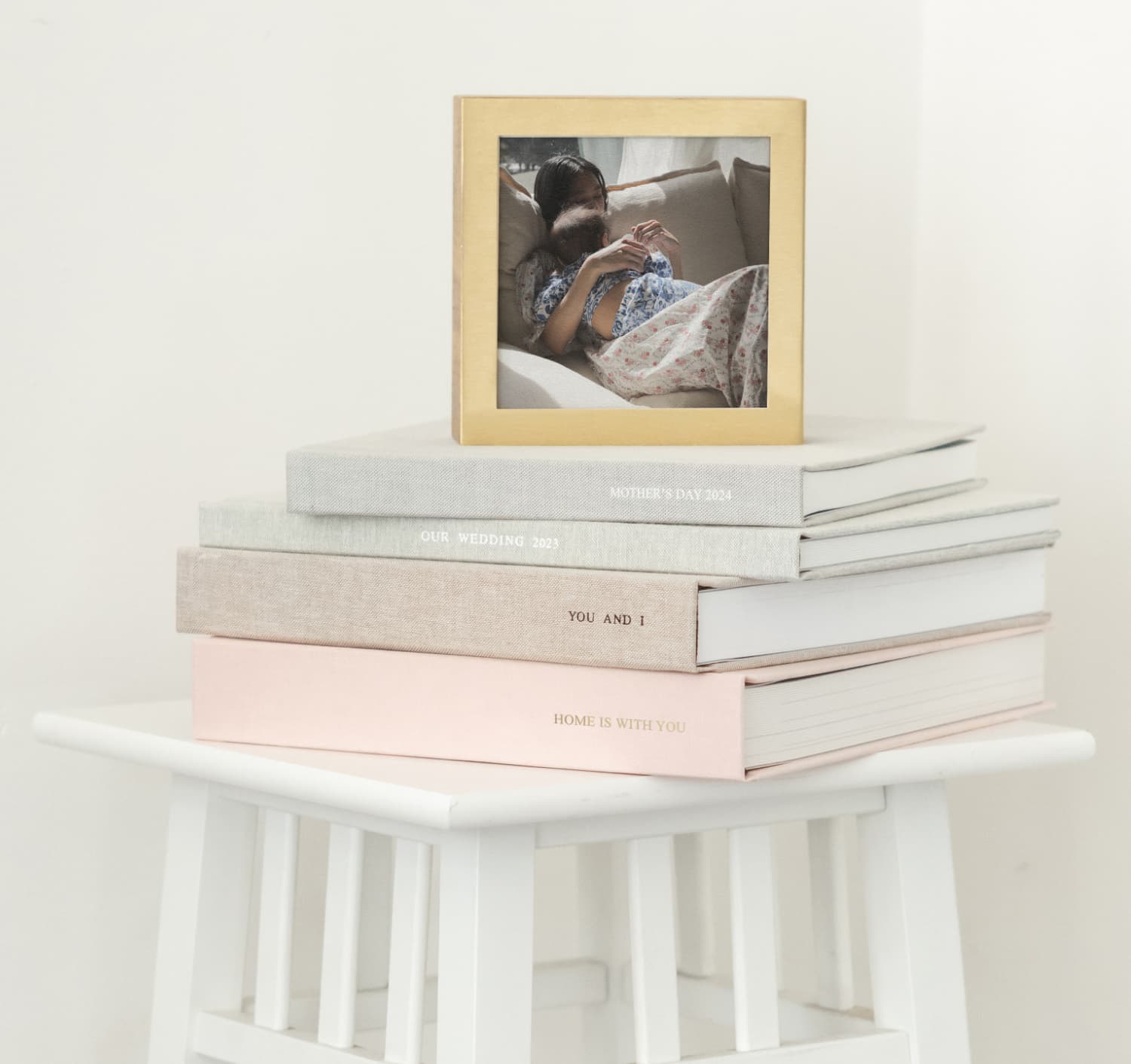 photo albums stacked showcasing brass & wood display box on top