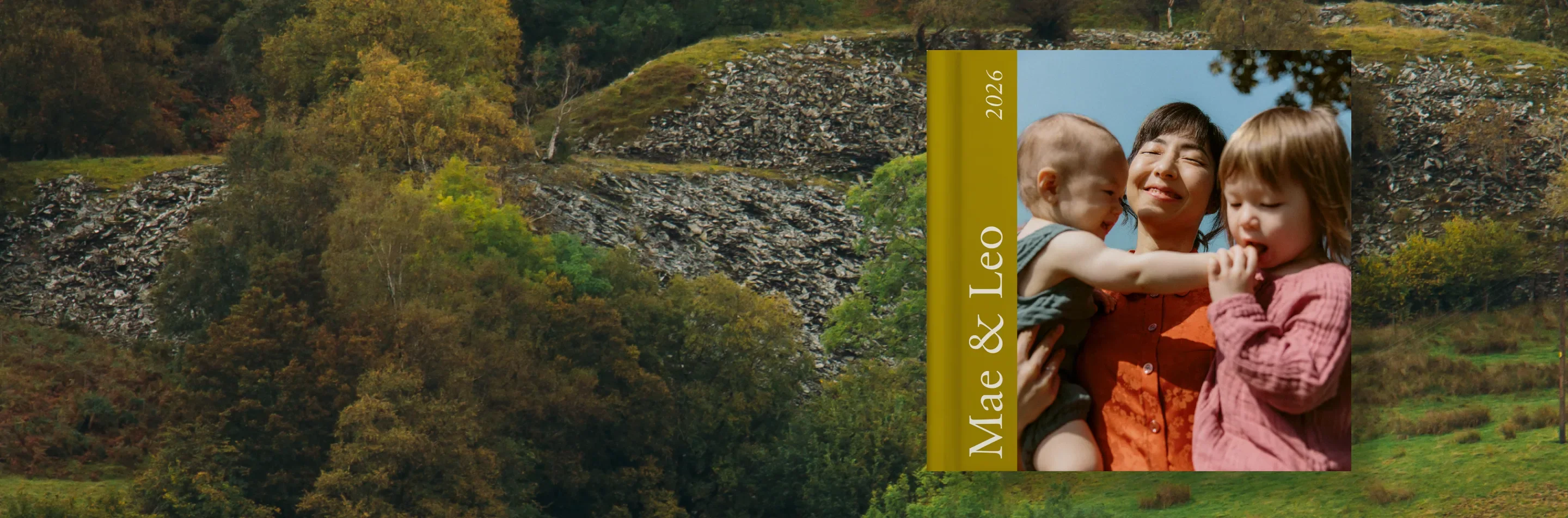 The Little Book with a family photo cover against an autumn landscape