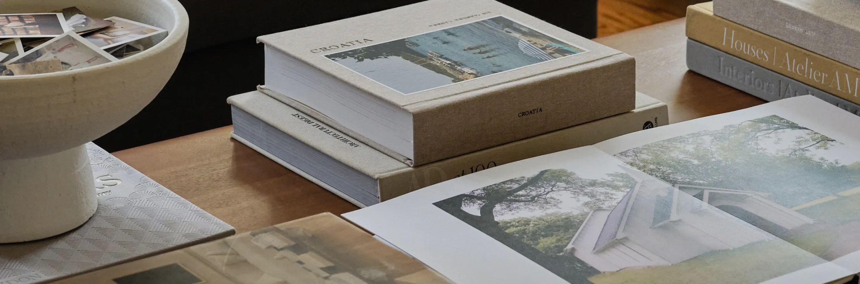 The Little Book with a family photo cover against an autumn landscape