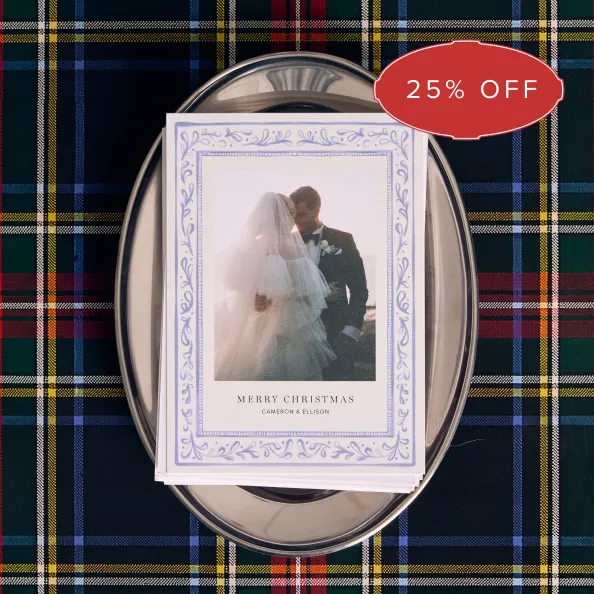 Personalized holiday card on a silver tray over plaid, with a 25% off badge