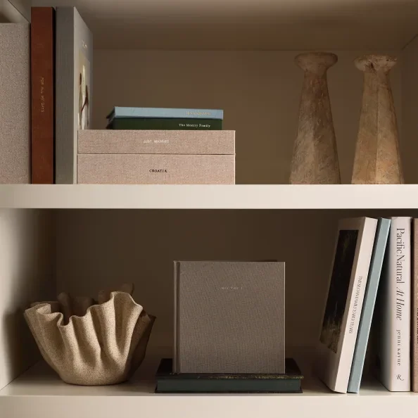 Photo books displayed on a shelf