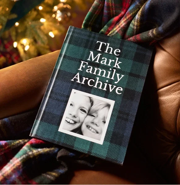 A family photo book beside the Christmas tree